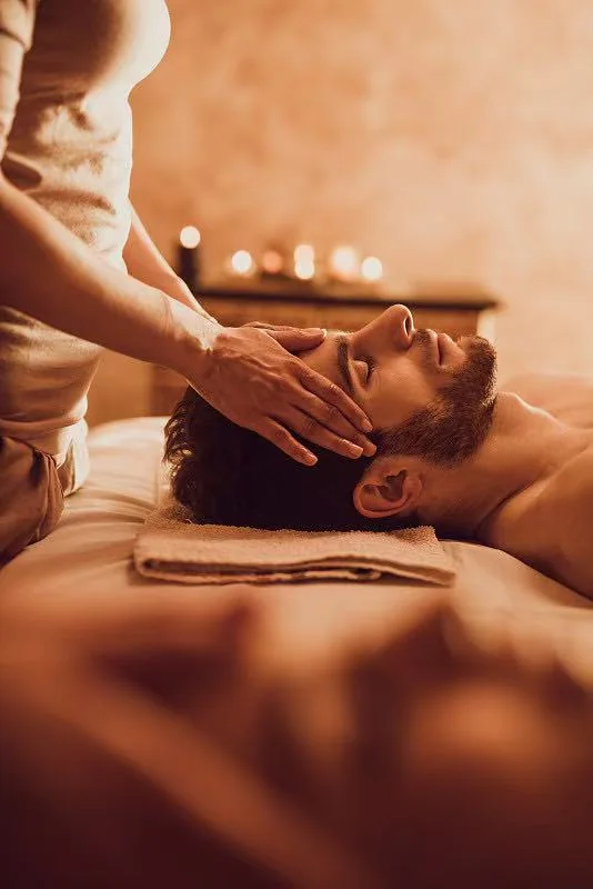 Gentle head and neck massage in a warm spa room