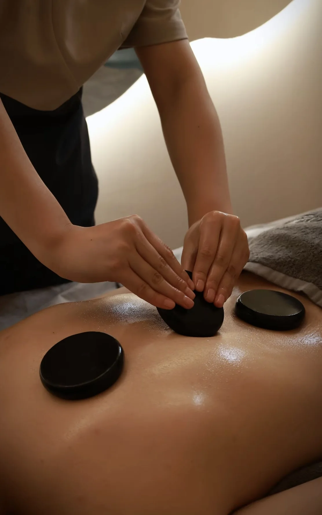 Smooth massage stones and warm-toned spa setting